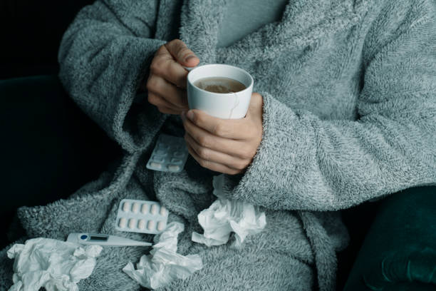 istock ill man at home warming up with a herbal tea 1916792684