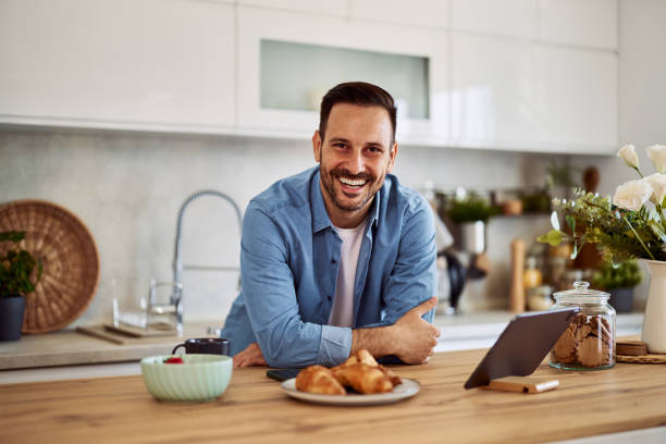 istock Portrait of a home chef leaning on a kitchen cabinet sharing ready to share cooking tips online. 1916793742