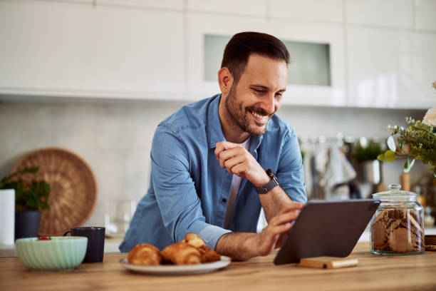 istock A happy homemaker searches for a recipe on a tablet while leaning on a kitchen counter. 1916793766