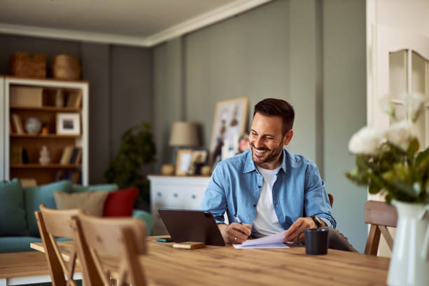 istock A smiling online tutor having an online class with his students on a tablet and taking notes. 1916799168