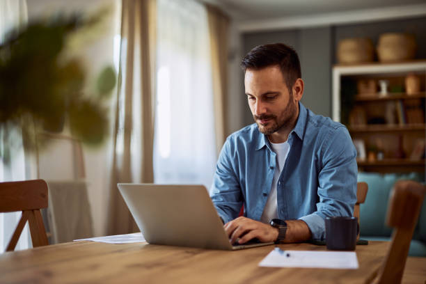 istock A focused male writer typing on his laptop while sitting at a table in a coffee shop. 1916800792