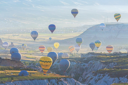 Hot Air Balloons flying up at sunrise. Cappadocia morning. Tourism, travelling. June 16, 2023. Goreme, Turkey (Turkiye)