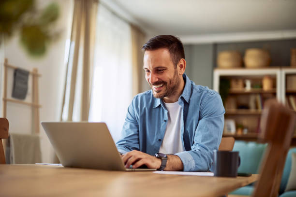 istock A happy male freelancer typing an email on his laptop to his client about a new project. 1916804556