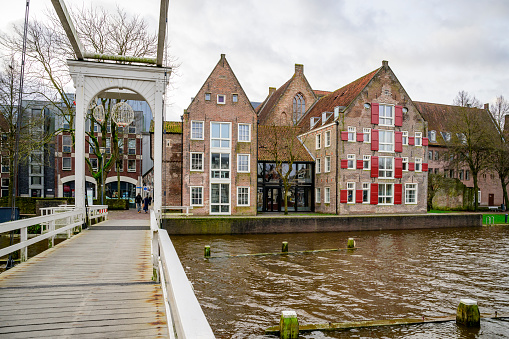 Torbeckegracht panoramic view with high water level in the canal in the city center of Zwolle during a dark winter day in Zwolle, Netherlands at the Pelserbrug.