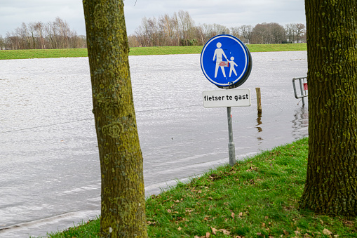 High water level in the river Vecht at the Vechterweerd weir in the Dutch Vechtdal region in Overijssel, The Netherlands. The river is overflowing on the floodplains after heavy rainfall upstream in The Netherlands and Germany in December 2023.