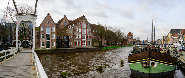 Torbeckegracht panoramic view with high water level in the canal in the city center of Zwolle during a dark winter day in Zwolle, Netherlands at the Pelserbrug.