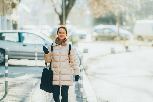 Woman with shopping bag walking down the street