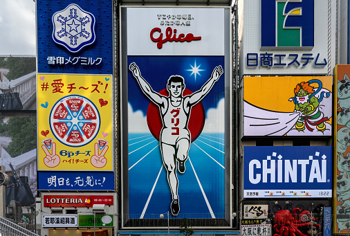 OSAKA, JAPAN - 29 Dec, 2023 : The most popular area of billboard for confectionery company Glico display the image of runner crossing a finishing line, is seen as icon of Osaka located at Japan.