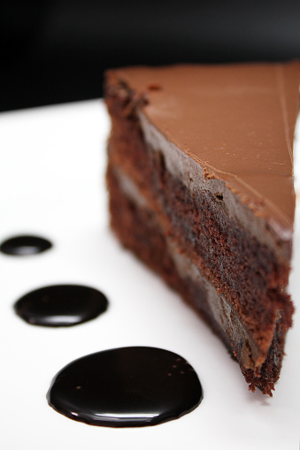 slice of three chocolate and cream cake