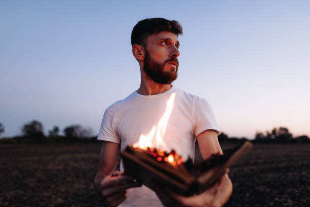istock Symbolic Act: Man Holds Burning Book in Hands 1916845199