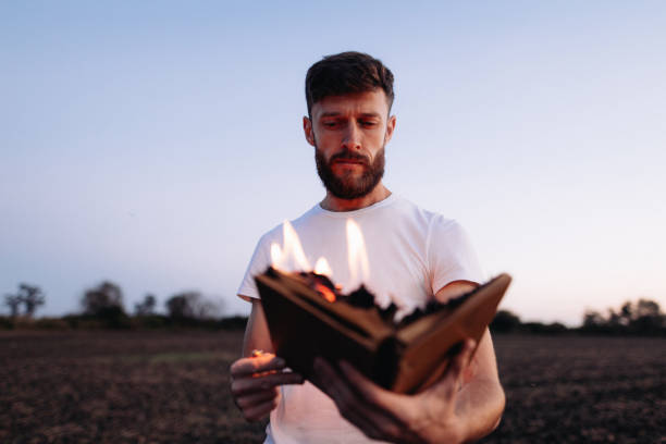 istock Symbolic Act: Man Holds Burning Book in Hands 1916846237
