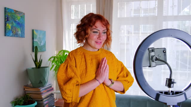 Excited influencer doing a vlog post in her living room