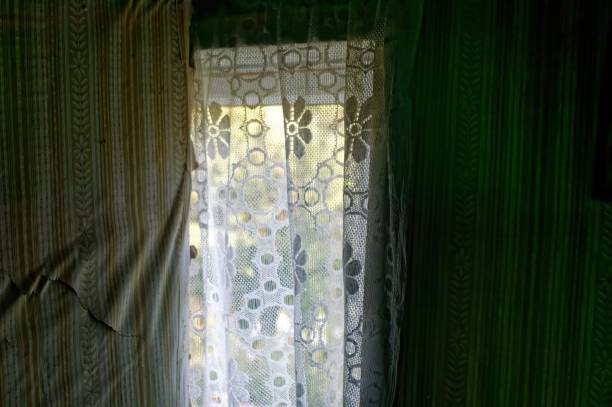 istock Window with curtains in a village house from the inside 1916876308