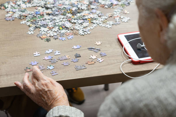 istock Senior woman doing a puzzle 1916885982