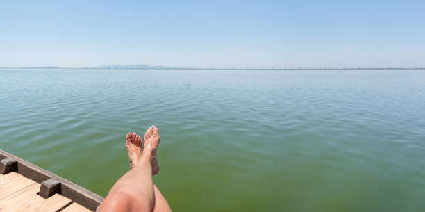 istock Tired legs on the boat with Mediterranean landscape 1916892843