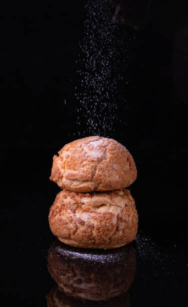 istock two Shu cakes stand in a stack on black glass 1916912238