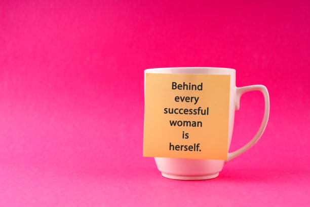 Inspirational quotes on adhesive note stick on a cup- Behind every successful woman is herself