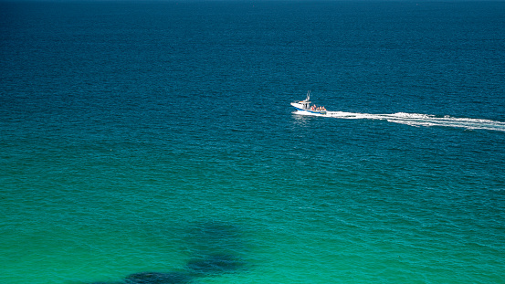 Aerial view of small boat in large bay of water