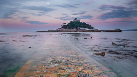 St. Michael's Mount, Cornwall, at sunrise. The causeway can be seen under the incoming tide, which is smooth and calm