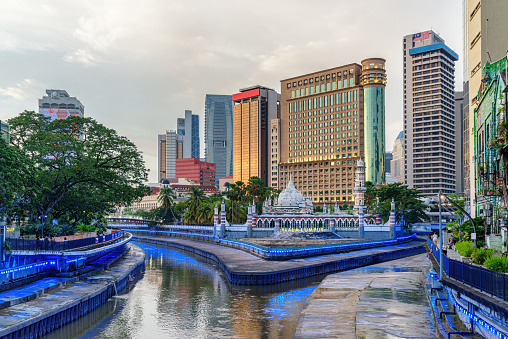 Awesome evening view of Jamek Mosque (Masjid Jamek Sultan Abdul Samad) at the confluence of the Klang and Gombak River in Kuala Lumpur, Malaysia. The Kolam Biru is a popular tourist attraction of Asia