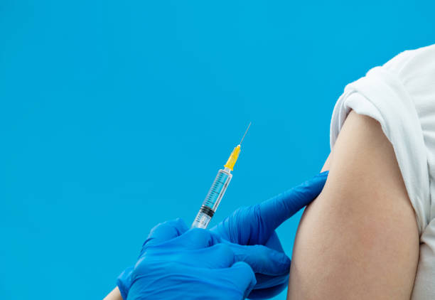 istock Doctor vaccinating for a boy on blue background 1917000947