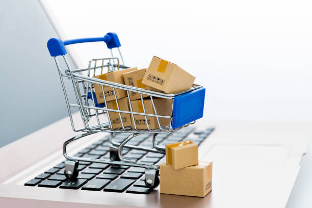 istock Shopping cart with small boxes on laptop keyboard 1917000950