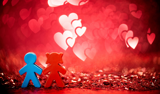 Couple figurine on shiny background.