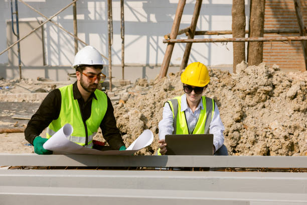 istock Engineers and Architect Caucasian looking at blueprint of building construction, planning the work in a professional. inspector is looking at steel structure and materials at construction site. 1917007309