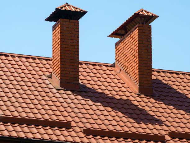 istock A brick chimneys on a brown metal tile roof 1917012637
