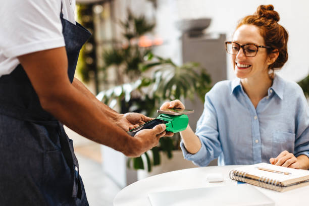 istock Cafe customer making a contactless payment with her smartphone 1917014778
