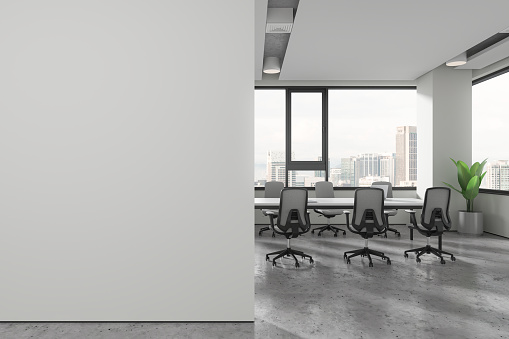 Interior of modern office meeting room with white walls, concrete floor, long conference table with gray chairs standing near big window and copy space wall on the left. 3d rendering