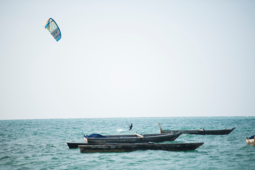 Zanzibar, Tanzania - January 02,2019: Tourists enjoy in kiteboarding on the sandy beaches of Zanzibar.