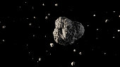 A large asteroid flying in outer space with small fragments.