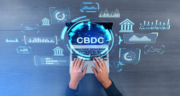 istock Man hands on laptop, CBDC glowing hologram hud with online statistics 1917026658