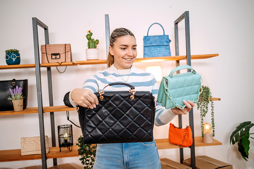 Young person begins new business with selling purses on line
