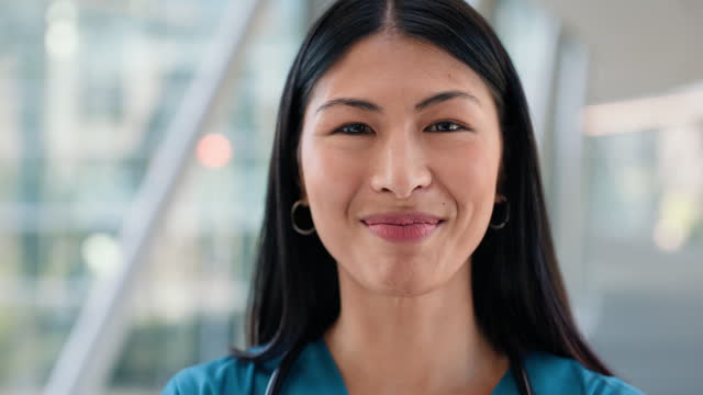 Woman, nurse and smile on face, confident and pride for career at hospital or clinic. Asian female person, medical professional and happy with healthcare, expert and consultation or trust in service