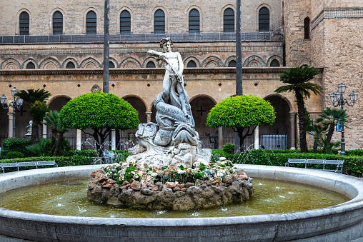 Triton Fountain or Fontana del Tritone next to the cathedral in the old town of Monreale, Palermo, Sicily, Italy