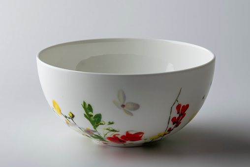 Single Empty Bowl Decorated with Painted Flowers Isolated on White Background
