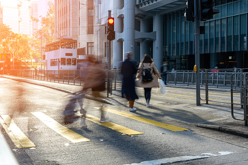 Busy city street people on zebra crossing at Hong Kong