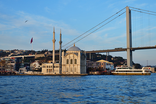 Istanbul; Turkey - December 10; 2023: View from Bosphorus  on Ortakoy Mosque  and  the Bosphorus Bridge or 15 July Martyrs Bridge