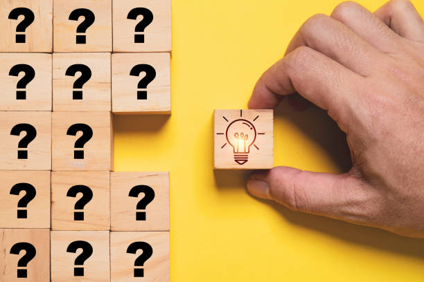 istock Glowing lightbulb print screen on wooden block cube and move out from question marks for creative thinking idea and problem solving solution concept. 1917064026