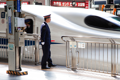 7th April 2012 - Osaka, Japan
Shinkansen N700 bullet train at a train station with station staff on the platform.