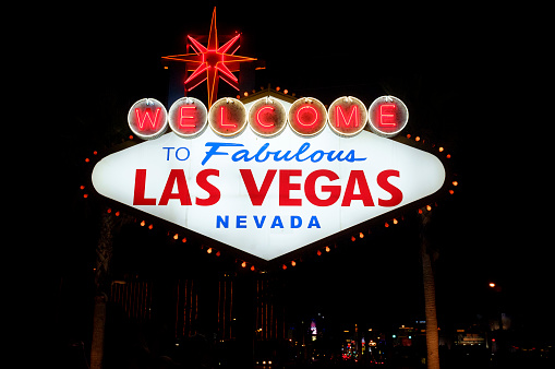 October 17, 2018 - Las Vegas, United States: Welcome To Fabulous Las Vegas Sign at sunset with a couple just married and his photographer behind