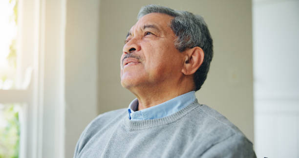 istock Thinking, nostalgia and senior man at a nursing home window with memory, moment or relax. Remember, face and elderly male person in a living room with reflection, calm or chilling in retirement 1917103030