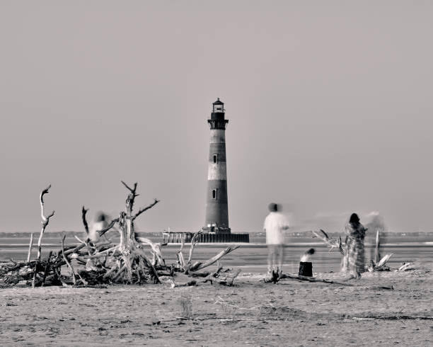 Folley Beach, South Carolina - 22 June 2022:  Sunset at Morris Island Lighthouse from Folley Beach.