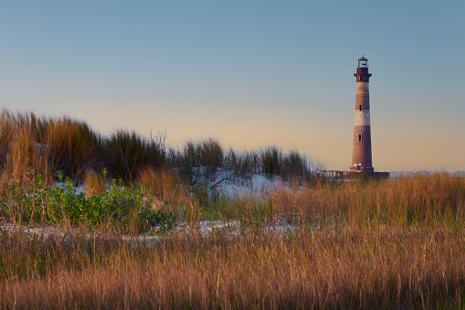 Folley Beach, South Carolina - 22 June 2022:  Sunset at Morris Island Lighthouse from Folley Beach.