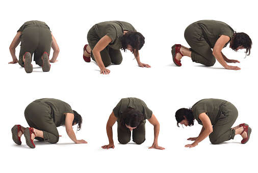 group of same woman on her knees searching or staring at something on the floor on white background