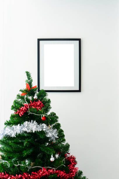 istock Black picture frame with christmas tree with ball on white wall 1917154783