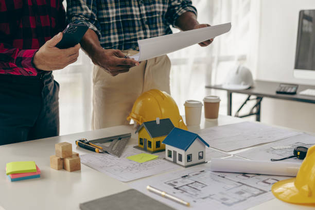 istock A team of construction workers and engineers meet to plan home construction and plan an office renovation project. The contractor talks to the architect and discusses the work in close proximity. 1917154785