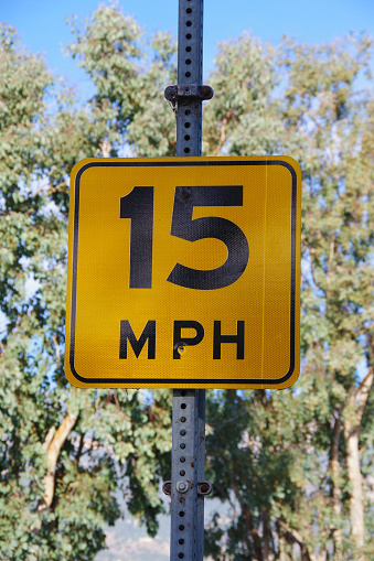 15 MPH yellow speed limit sign